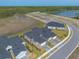 Wide aerial shot showcases the property's proximity to lush green spaces, lakes, and developing areas at 6456 Roseberry Ct, Port Orange, FL 32128