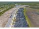 View of modern gray townhomes, nearby pond, and landscaping at 6456 Roseberry Ct, Port Orange, FL 32128