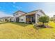 Rear view of a two-story home, showcasing a screened lanai and well-maintained lawn at 6456 Roseberry Ct, Port Orange, FL 32128