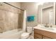 Bright bathroom featuring tiled walls, shower-tub combo, and modern vanity with a single sink at 6456 Roseberry Ct, Port Orange, FL 32128