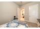 A carpeted bedroom features a view into an adjoining bathroom, closet, and doorway at 6456 Roseberry Ct, Port Orange, FL 32128