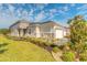 Beautiful exterior showcasing landscaped grounds and a pristine two-car garage, adding curb appeal at 6456 Roseberry Ct, Port Orange, FL 32128