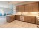 Open kitchen with modern appliances, granite countertops, custom cabinetry, and a breakfast bar at 6456 Roseberry Ct, Port Orange, FL 32128