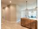 Spacious kitchen island featuring a wooden cabinet base, light countertop, and modern pendant lighting above at 6456 Roseberry Ct, Port Orange, FL 32128