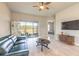 Cozy living room with sliding glass doors and TV. View into the bedroom at 6456 Roseberry Ct, Port Orange, FL 32128