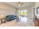 Bright living room features tile flooring, neutral walls, and sliding glass doors to the outdoors at 6456 Roseberry Ct, Port Orange, FL 32128