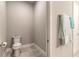 Simple powder room featuring a toilet and towel rack at 6456 Roseberry Ct, Port Orange, FL 32128