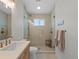 Modern bathroom featuring walk-in shower with glass door and wooden vanity at 6530 S Atlantic Ave, New Smyrna Beach, FL 32169