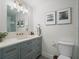 Modern bathroom featuring blue vanity with quartz countertop, and shower with glass enclosure at 6530 S Atlantic Ave, New Smyrna Beach, FL 32169