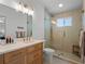 Bathroom with modern vanity and a large walk-in shower with glass door at 6530 S Atlantic Ave, New Smyrna Beach, FL 32169