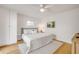 Bright bedroom features a comfortable bed, ceiling fan, and minimalist decor at 6530 S Atlantic Ave, New Smyrna Beach, FL 32169