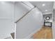Hallway with white paneled walls, wooden floors, and console table with decorations at 6530 S Atlantic Ave, New Smyrna Beach, FL 32169
