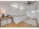 Bright hallway with hardwood floors, modern lighting, and white paneled accent wall at 6530 S Atlantic Ave, New Smyrna Beach, FL 32169