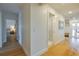 Hallway features hardwood floors, white walls, leading to a bathroom and mudroom at 6530 S Atlantic Ave, New Smyrna Beach, FL 32169