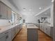 An open kitchen flows into the living area, featuring an island cooktop and ample counter space at 6530 S Atlantic Ave, New Smyrna Beach, FL 32169