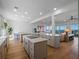 An open-concept kitchen with quartz countertops, wood floors, and views of the living area and ocean at 6530 S Atlantic Ave, New Smyrna Beach, FL 32169