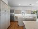 A bright kitchen boasts stainless steel appliances, shaker cabinets, and an island with a built-in cooktop at 6530 S Atlantic Ave, New Smyrna Beach, FL 32169