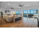 Open living room with ocean views, hardwood floors, and comfortable sectional sofa at 6530 S Atlantic Ave, New Smyrna Beach, FL 32169