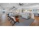 Open-concept living area with ocean view, sectional sofa, kitchen, and staircase at 6530 S Atlantic Ave, New Smyrna Beach, FL 32169