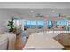 A living room with an ocean view extends from an open-concept kitchen with a bright and airy feel at 6530 S Atlantic Ave, New Smyrna Beach, FL 32169