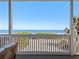 A stunning ocean view from the cozy covered patio features beach foliage and the blue Atlantic Ocean at 6530 S Atlantic Ave, New Smyrna Beach, FL 32169