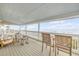 Spacious covered porch with ample seating and ocean views, perfect for outdoor living at 6530 S Atlantic Ave, New Smyrna Beach, FL 32169