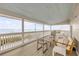 Relaxing covered porch featuring comfortable seating and stunning views of the ocean at 6530 S Atlantic Ave, New Smyrna Beach, FL 32169