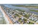 Overhead view of a coastal community nestled between the ocean and river with charming waterfront homes at 6860 Turtlemound Rd, New Smyrna Beach, FL 32169
