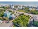 Aerial view of a colorful coastal community with lush greenery and beach access at 6860 Turtlemound Rd, New Smyrna Beach, FL 32169
