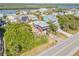 Aerial view of a charming blue two-story home with covered parking in a coastal community near a river and the ocean at 6860 Turtlemound Rd, New Smyrna Beach, FL 32169