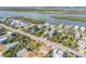 Aerial shot showcasing waterfront homes with easy access to a serene river and lush greenery at 6860 Turtlemound Rd, New Smyrna Beach, FL 32169