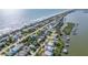 Stunning aerial perspective of the house, perfectly positioned between the ocean and river in a bustling community at 6860 Turtlemound Rd, New Smyrna Beach, FL 32169