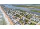 Breathtaking aerial view showing the house's perfect location between the ocean and river in a thriving community at 6860 Turtlemound Rd, New Smyrna Beach, FL 32169