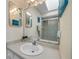 Bathroom sink with large mirror, lighting, art on the wall, and a view of the shower stall at 6860 Turtlemound Rd, New Smyrna Beach, FL 32169