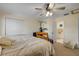 Comfortable bedroom with exercise equipment and adjacent bathroom offers convenience and privacy at 6860 Turtlemound Rd, New Smyrna Beach, FL 32169