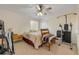 Cozy bedroom with neutral decor, ceiling fan, and natural light offers comfortable retreat at 6860 Turtlemound Rd, New Smyrna Beach, FL 32169