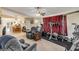 Versatile bonus room with fitness equipment, living area, and easy access to kitchen at 6860 Turtlemound Rd, New Smyrna Beach, FL 32169