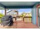 Outdoor deck with a grill, wooden railing, and views of the neighborhood at 6860 Turtlemound Rd, New Smyrna Beach, FL 32169