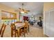 Dining area with a tropical view, flowing into a living area with comfortable seating and ample natural light at 6860 Turtlemound Rd, New Smyrna Beach, FL 32169