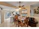Bright dining area with tile floors, adjacent to the kitchen, featuring a view of the outdoors and plenty of natural light at 6860 Turtlemound Rd, New Smyrna Beach, FL 32169