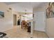 Inviting entryway with tile flooring leading to an open-concept dining area and a glimpse of the bright kitchen at 6860 Turtlemound Rd, New Smyrna Beach, FL 32169