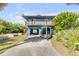 Charming blue two-story home with a cozy balcony and covered parking for vehicles or boats at 6860 Turtlemound Rd, New Smyrna Beach, FL 32169