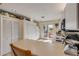 Bright kitchen features white appliances, ample storage, and sliding glass doors to outdoor deck at 6860 Turtlemound Rd, New Smyrna Beach, FL 32169