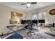 Bright office space featuring a ceiling fan, multiple computer monitors, and natural light at 6860 Turtlemound Rd, New Smyrna Beach, FL 32169