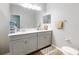 Bathroom features a double sink vanity with modern fixtures and a large mirror at 727 Porter Rye Ave, Debary, FL 32713