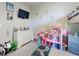 bedroom with bunkbeds, wall-mounted TV, and dollhouse at 727 Porter Rye Ave, Debary, FL 32713