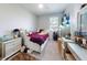 This bedroom showcases a cozy space with a large window for natural light and a ceiling fan at 727 Porter Rye Ave, Debary, FL 32713