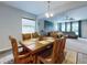 Open dining room featuring wood table, six chairs, carpet, and view into the living room at 727 Porter Rye Ave, Debary, FL 32713