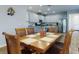 Open dining room featuring wood table, six chairs, and view into the kitchen at 727 Porter Rye Ave, Debary, FL 32713
