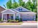 Charming single-Gathering home features a gray exterior, brick driveway, and inviting front porch with seating at 727 Porter Rye Ave, Debary, FL 32713